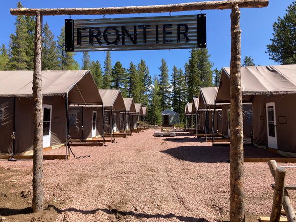 Ten Custom Lodge Cabin Tents at a lakeside summer camp