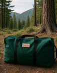 Forest green canvas tote bag with black straps and Colorado Tent logo