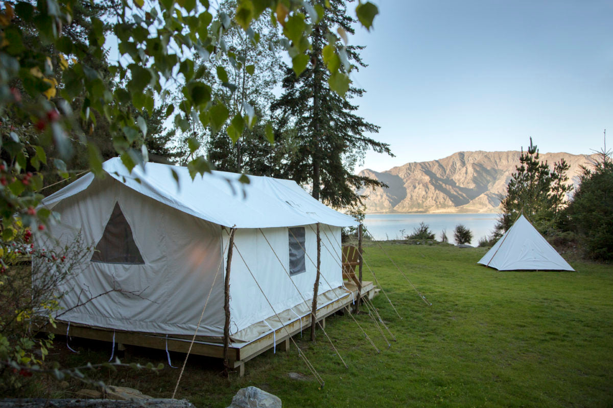 Canvas wall tent and Cowboy Tipi lakeside
