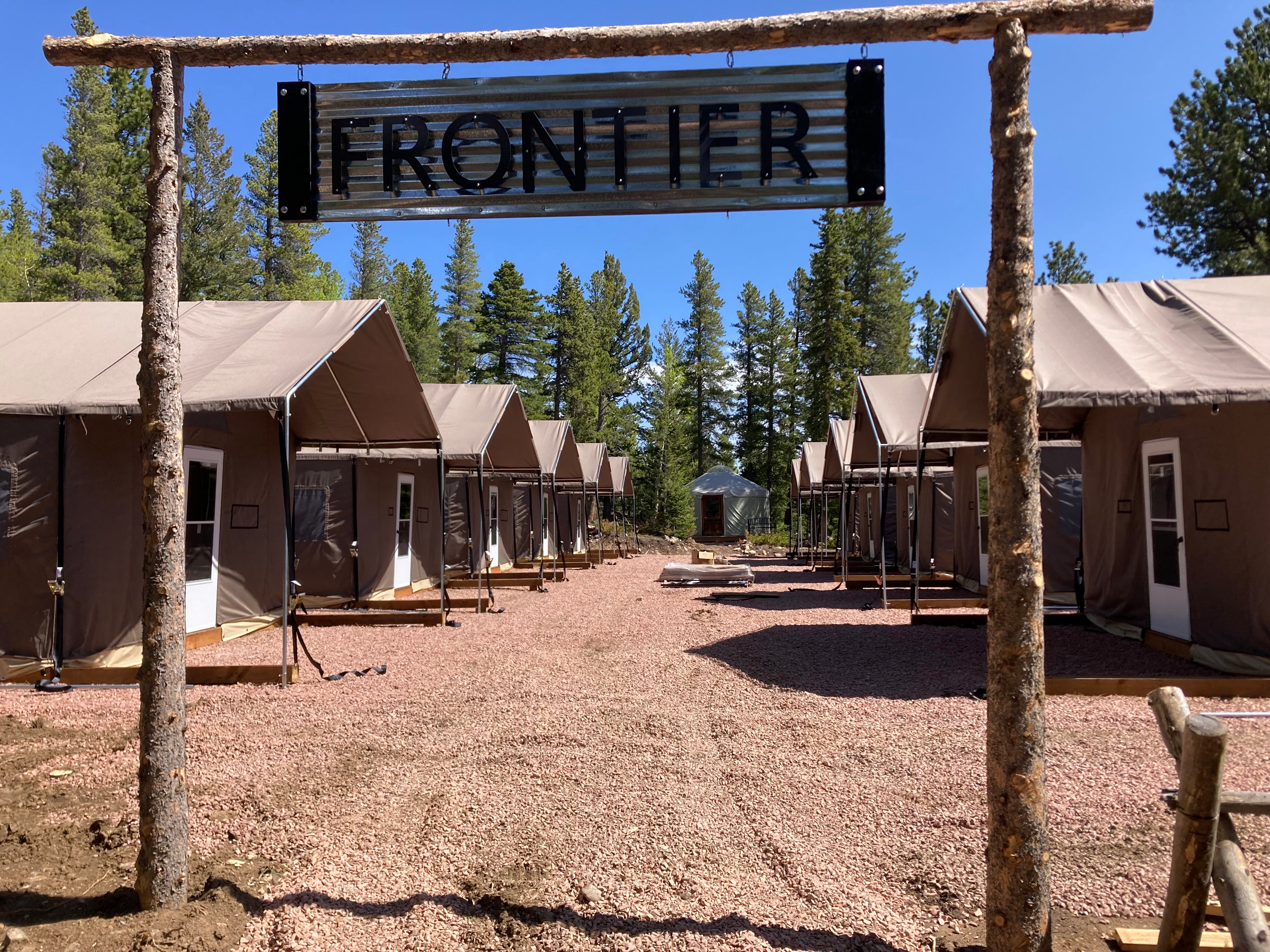 Ten Custom Lodge Cabin Tents at a lakeside summer camp
