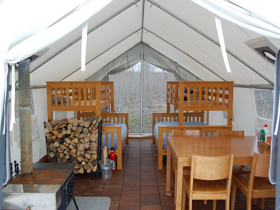 Bunk Bed Interior of Colorado wall tent showing forest view through open door