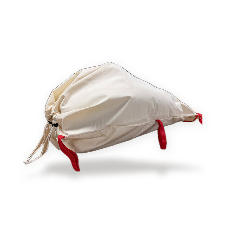 Canvas Game Bag filled and cinched shut, with red webbing hanging loops, on a white background