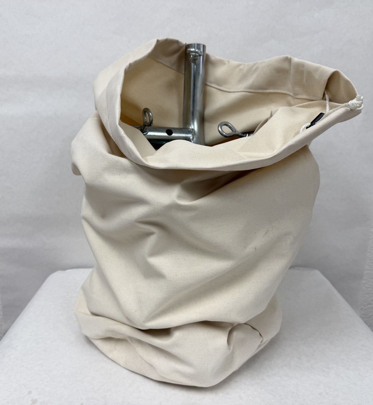 Natural canvas Coupler Bag open with steel tent frame couplers inside