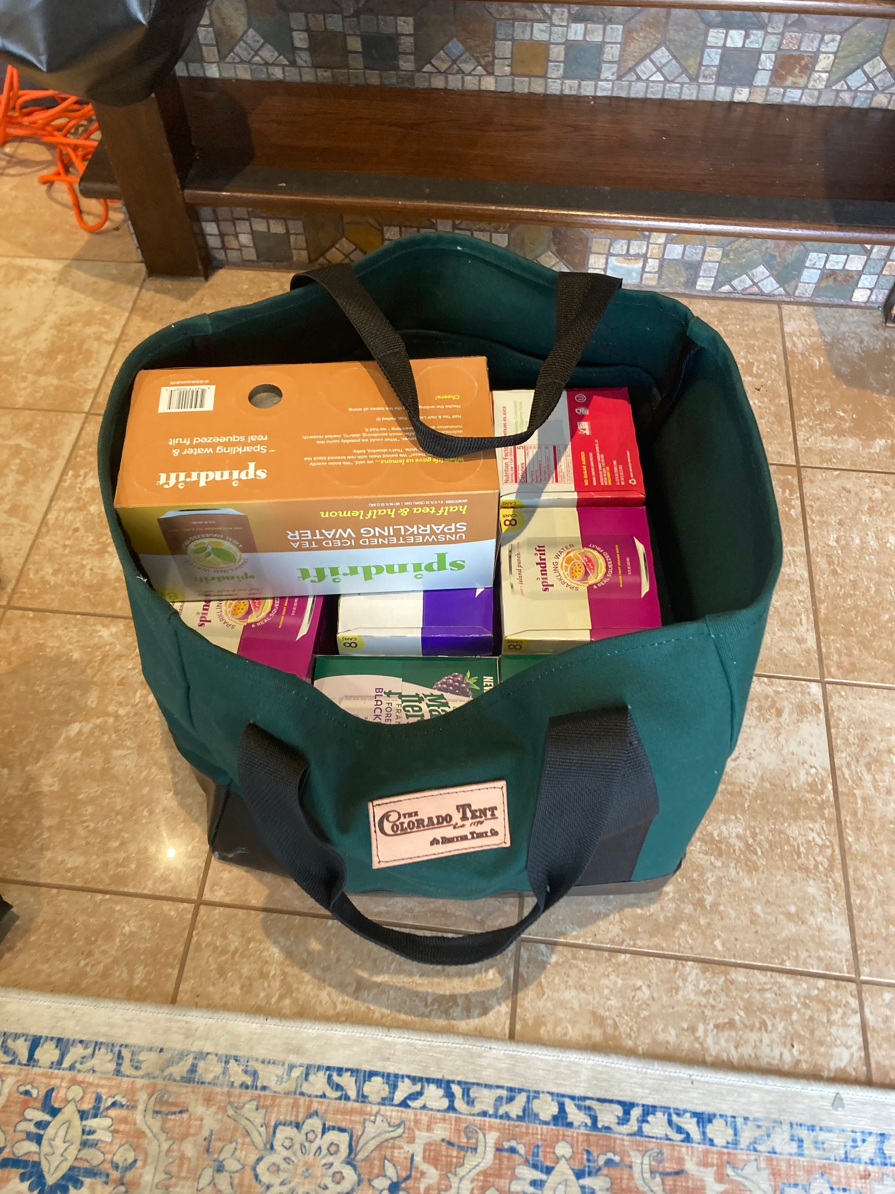 Forest green canvas tote bag with black straps and Colorado Tent logo