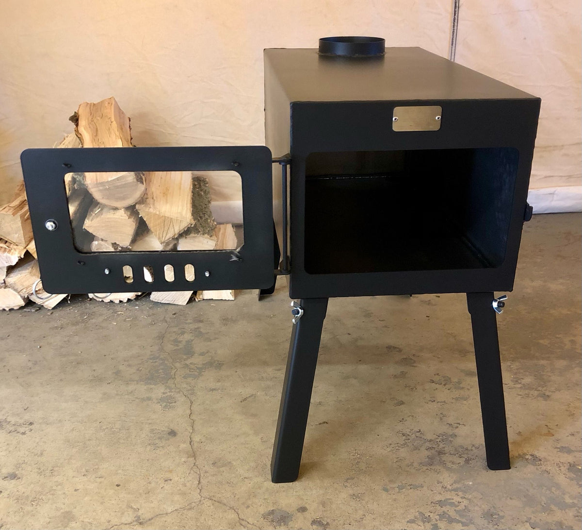 Explorer Wood Stove Kit by North Woods Fabrication, door open to the firebox
