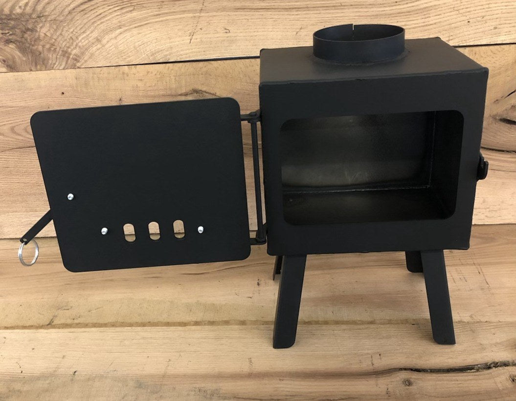 Mini Base Camp Wood Stove by North Woods Fabrication, door open to the firebox