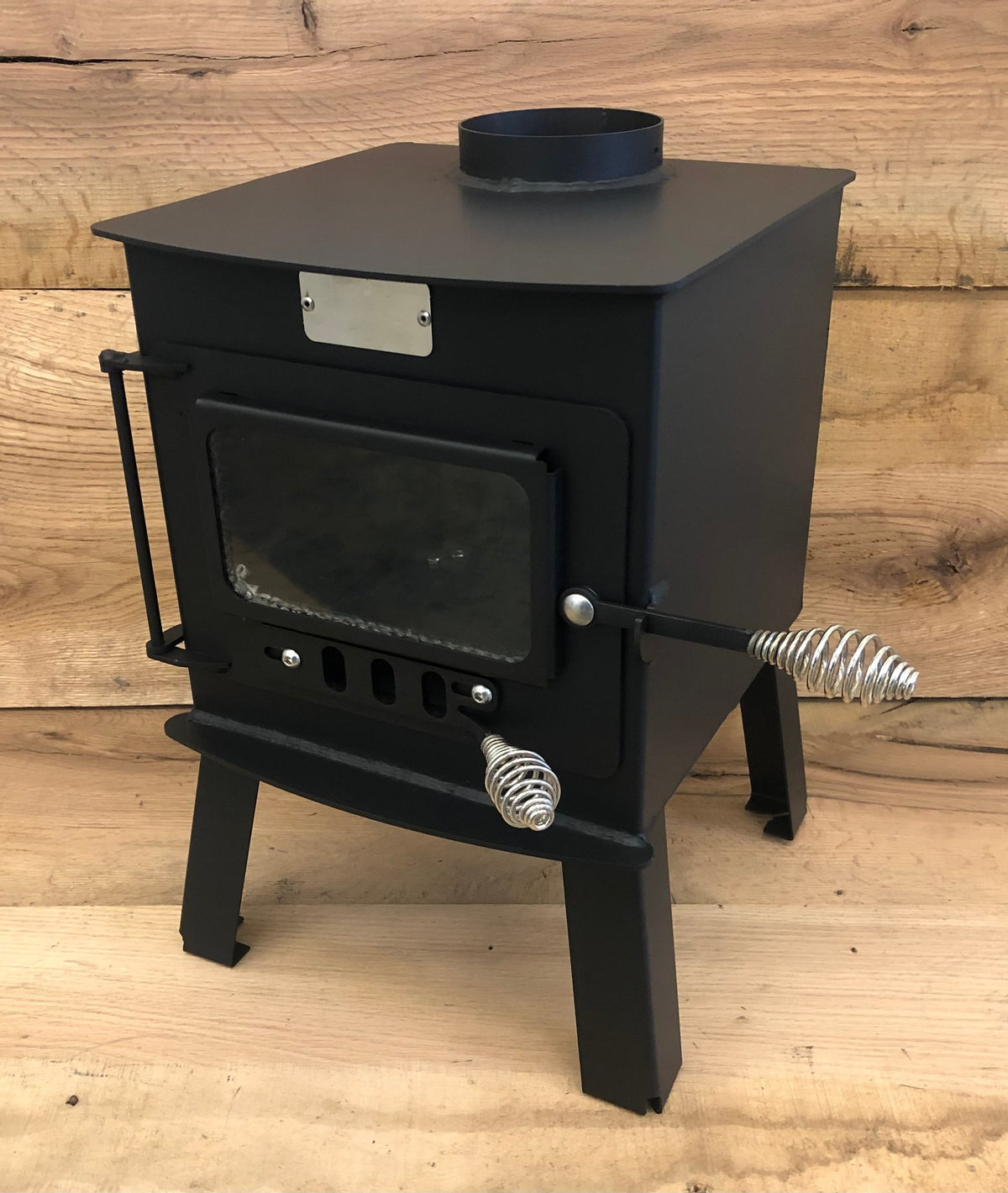 Mini Woodsman Wood Stove by North Woods Fabrication, front three-quarter view