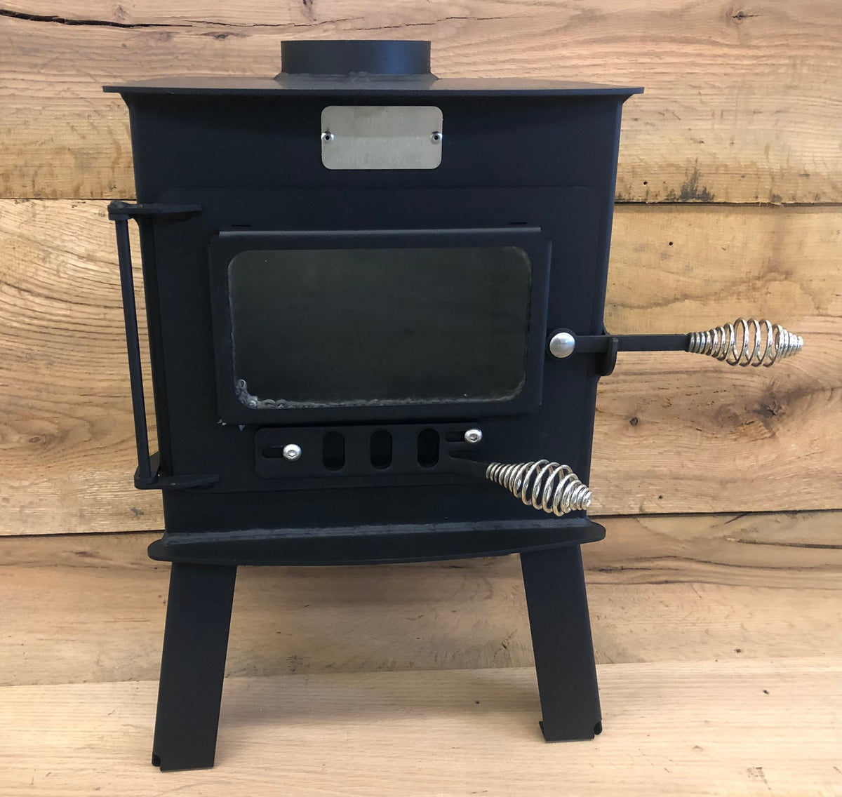 Mini Woodsman Wood Stove by North Woods Fabrication, front view with glass door
