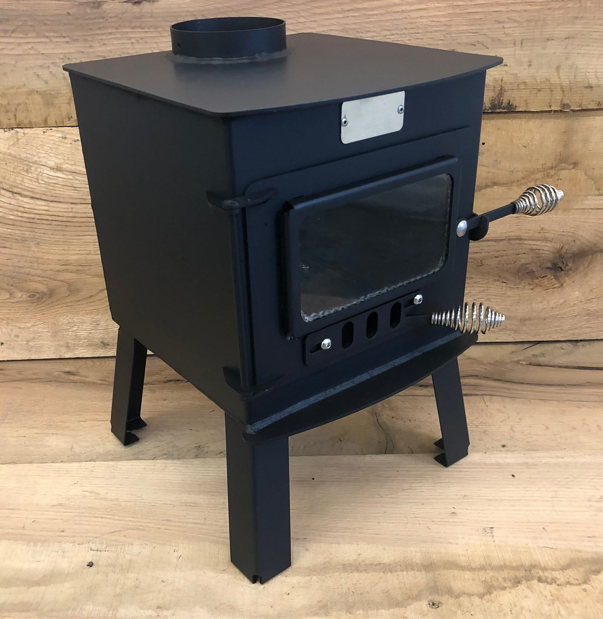 Mini Woodsman Wood Stove by North Woods Fabrication, three-quarter view from the right