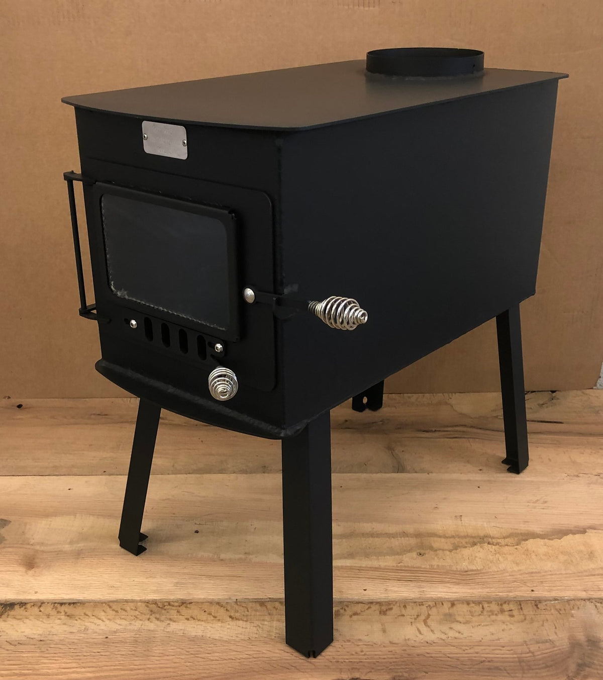 Woodsman XL Wood Stove by North Woods Fabrication, three-quarter view showing the long firebox