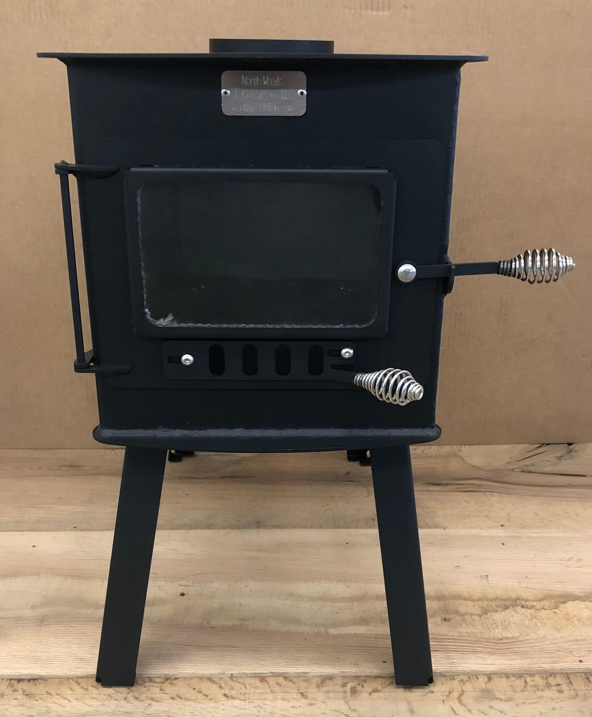 Woodsman XL Wood Stove by North Woods Fabrication, front view with glass door