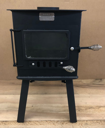 Woodsman XL Wood Stove by North Woods Fabrication, front view with glass door