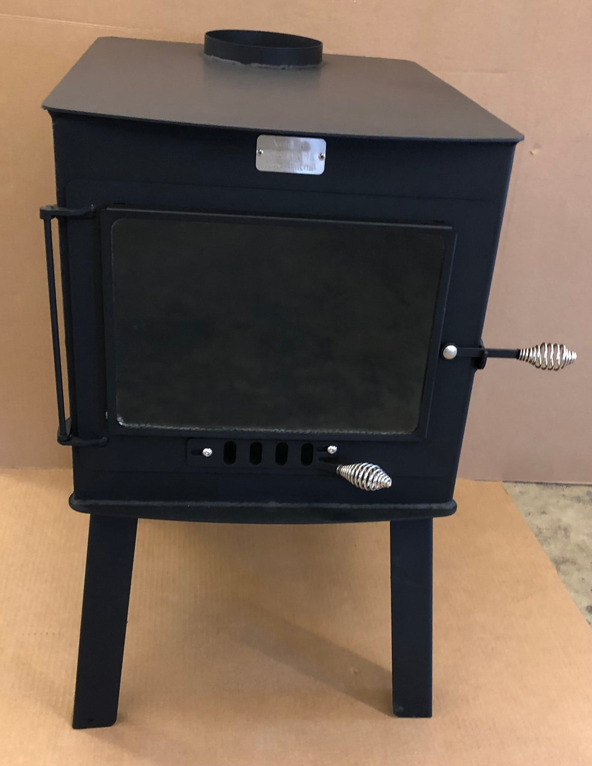 Woodsman XXL Wood Stove by North Woods Fabrication, front view with the large glass door