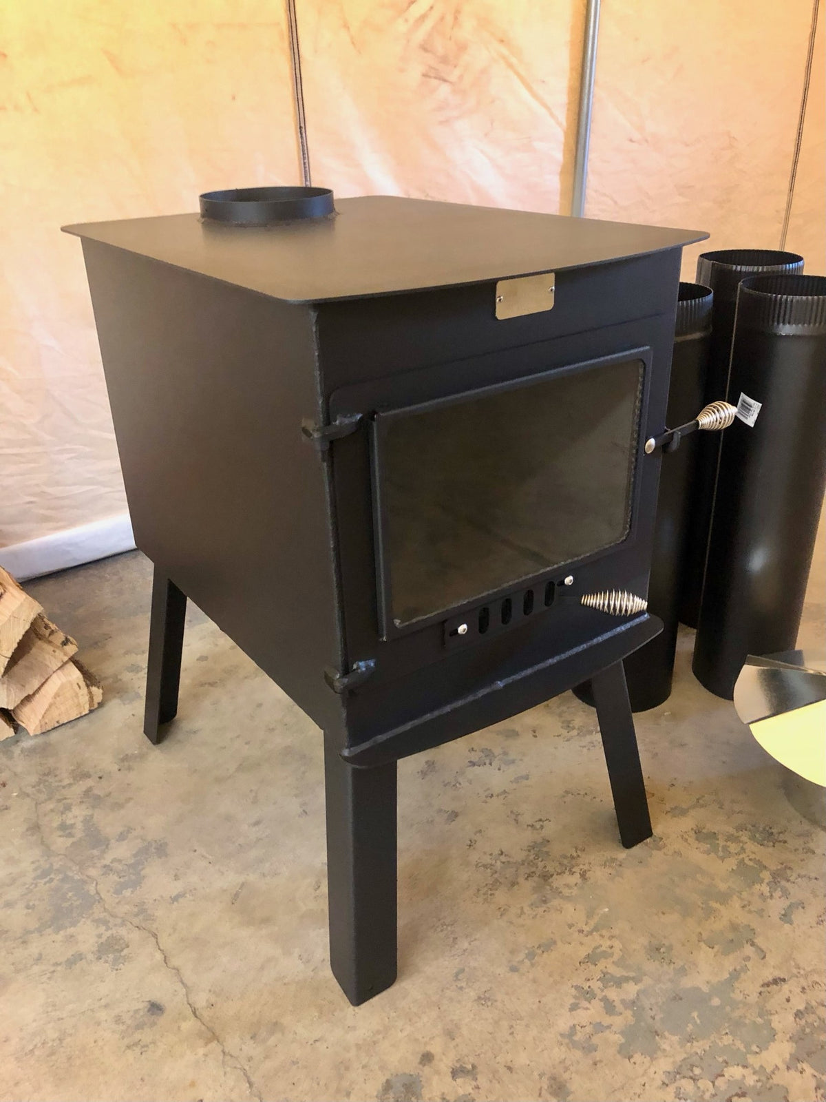 Woodsman XXL Stove Kit by North Woods Fabrication, three-quarter view with stove pipe