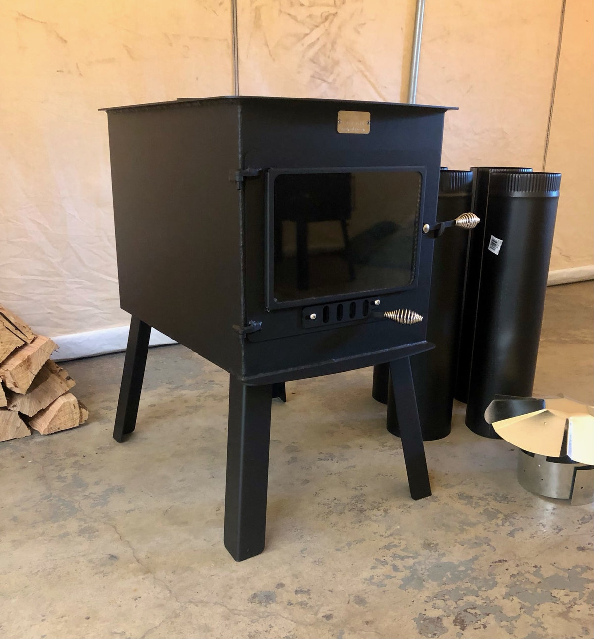Woodsman XXL Stove Kit by North Woods Fabrication, front view with stove pipe and rain cap