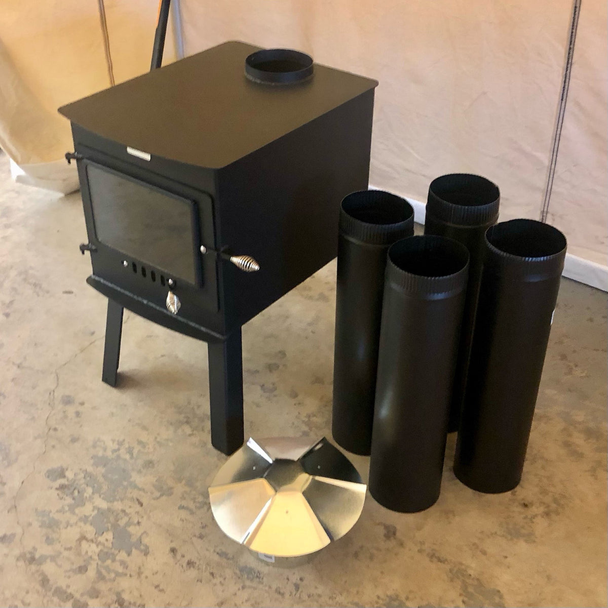 Woodsman XXL Stove Kit by North Woods Fabrication, with four sections of 6 in stove pipe and a rain cap
