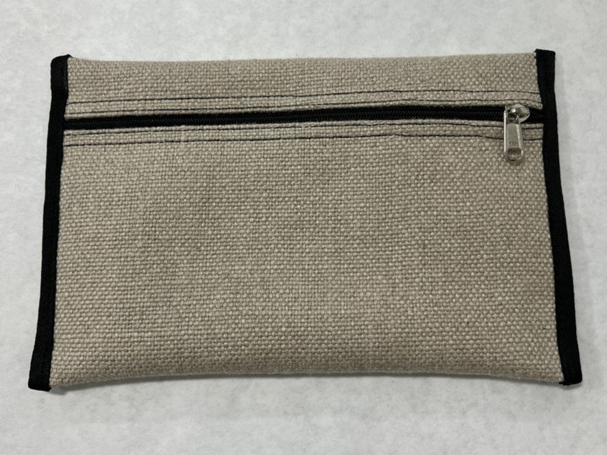 Flat canvas tackle pocket with a black zipper and black edge binding on a white surface.